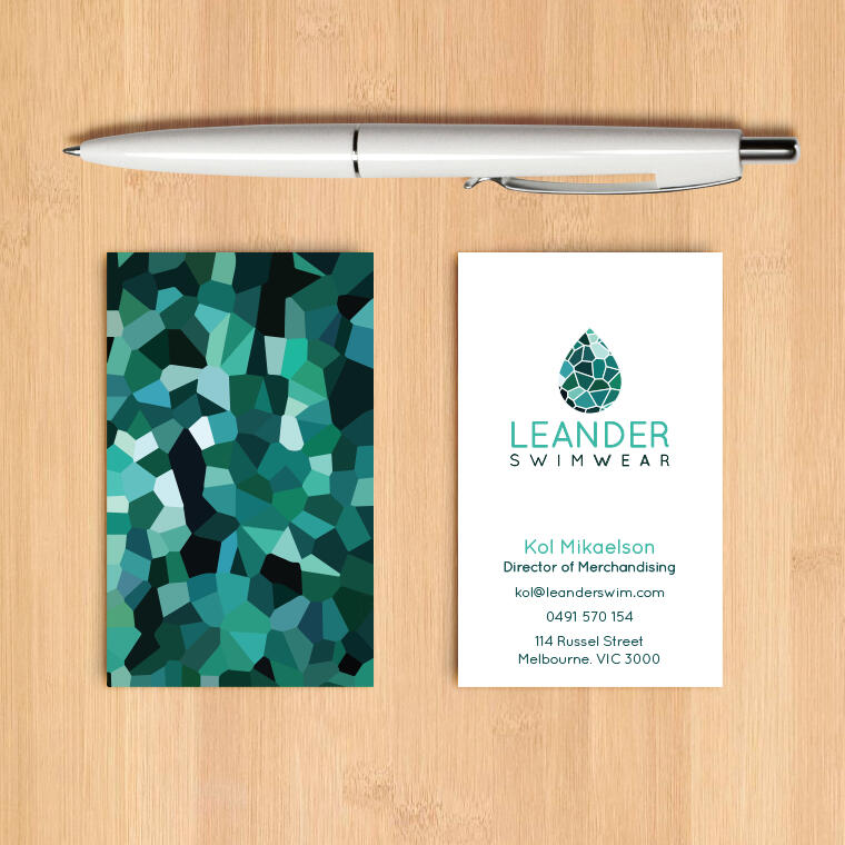 Client work preview image for Leander Swimwear. Preview shows the front and back of a business card design along with a pen on a light wood background.